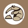 Zotmeal's Logo: a beige anteater with a bushy tail sitting next to an anthill.